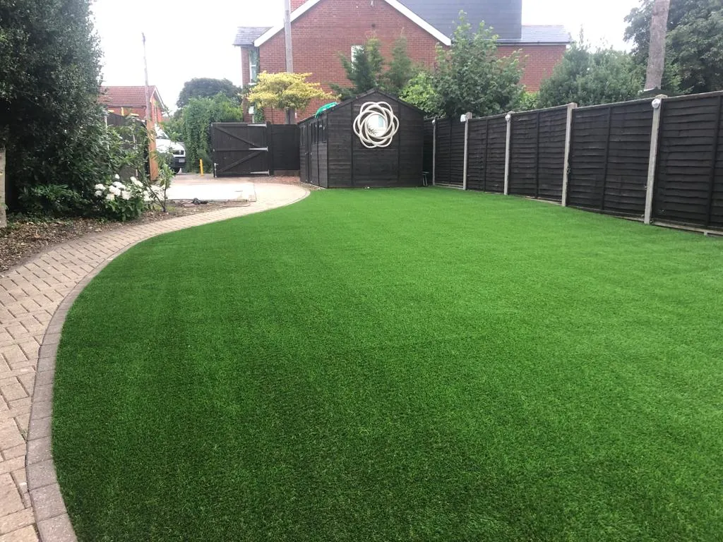 artificial grass next to black shed