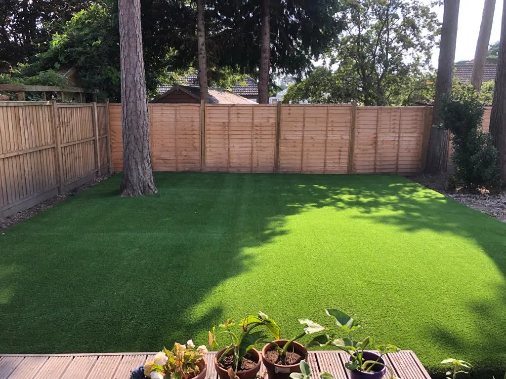 smooth artificial grass next to fence