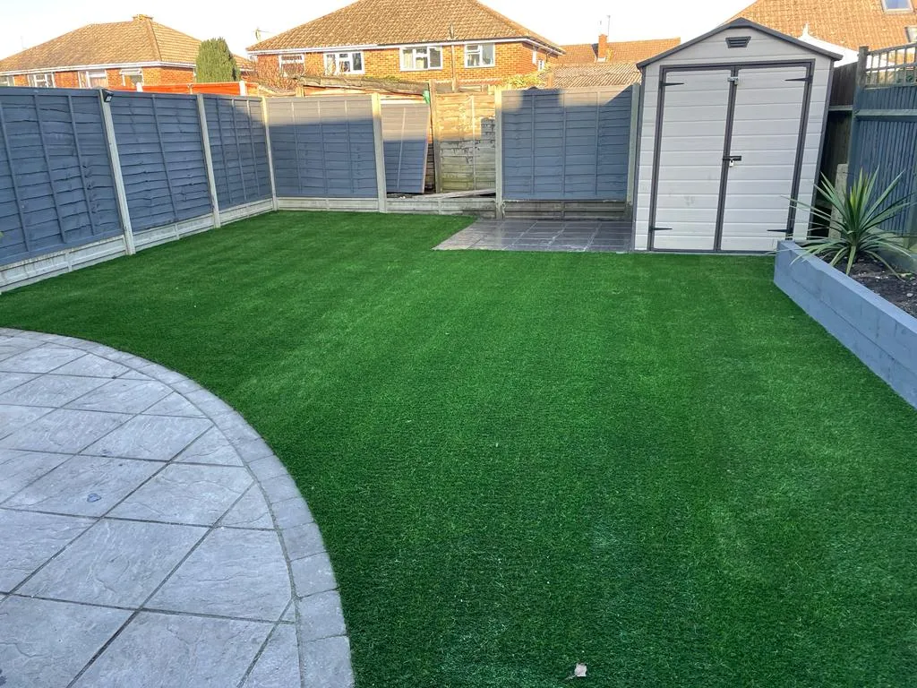 artificial grass around white shed